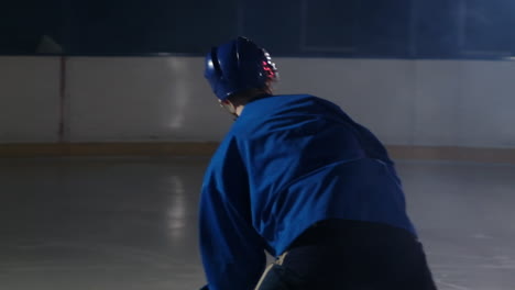 Professional-athlete-male-hockey-player-turns-in-front-of-the-camera-with-a-puck-and-strikes-the-opponent's-goal-and-scores